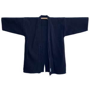Black overdyed kendo jacket with handwritten tag at hem