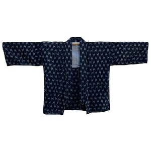 May include: A black and white patterned kimono with a simple design. The kimono is made of a lightweight fabric and has a relaxed fit.