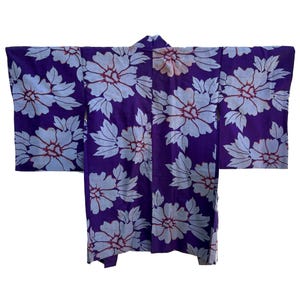 May include: A purple and white floral patterned Japanese kimono. The kimono has a traditional design with large white flowers on a purple background.