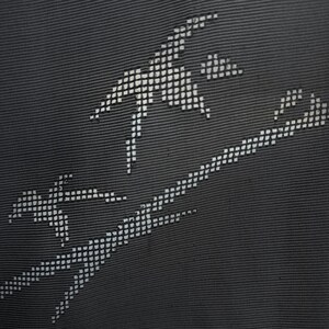 May include: Close-up of a dark gray fabric with a textured surface. The fabric features a white, dotted design that resembles abstract figures or shapes. The design is composed of small, evenly spaced dots.