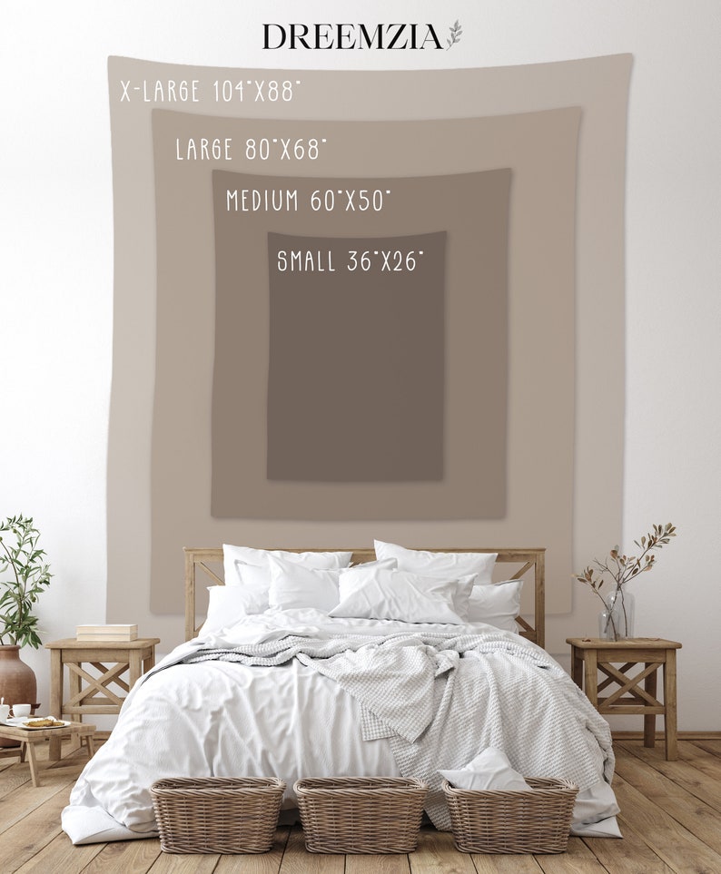 May include: A white bed with a white blanket and pillows, a brown wooden headboard, and two wicker baskets at the foot of the bed. The bed is in front of a wall with a beige tapestry hanging on it. The tapestry has text that reads "X-LARGE 101"x88", "LARGE 80"x68", "MEDIUM 60"x50", and "SMALL 36"x26".