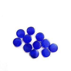 May include: A group of ten round, blue, glass buttons. The buttons are smooth and shiny.