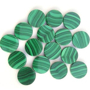 May include: A collection of 15 round green malachite cabochons. The cabochons are smooth and polished, with a variety of green patterns.
