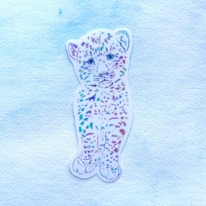 May include: A colorful line drawing of a leopard cub, with a white background.