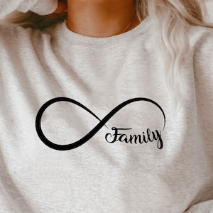 May include: A gray sweatshirt with an infinity symbol and the word "Family" printed in black.