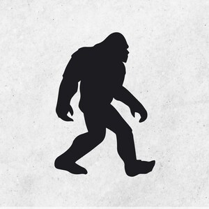 May include: Black silhouette of a Bigfoot walking to the right. The creature is walking on two legs and has large feet.