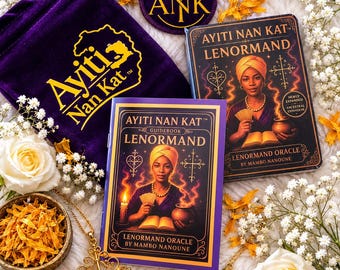 May include: A Lenormand oracle deck and guidebook titled Ayiti Nan Kat, featuring a purple velvet drawstring bag with gold embroidery, a gold cross pendant, a gold pendulum, and a small bowl of dried yellow flower petals on a white surface.
