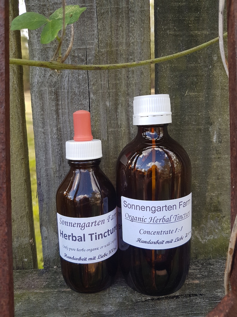 Two SonnengartenOrganics Herbal Tincture Bottles. 
Handarbeit mit Liebe (Hand Made with Love). This is the true essence of our work.
Hans the Herbalist puts a lot of thought, love and over forty years of experience into making his tinctures for you.