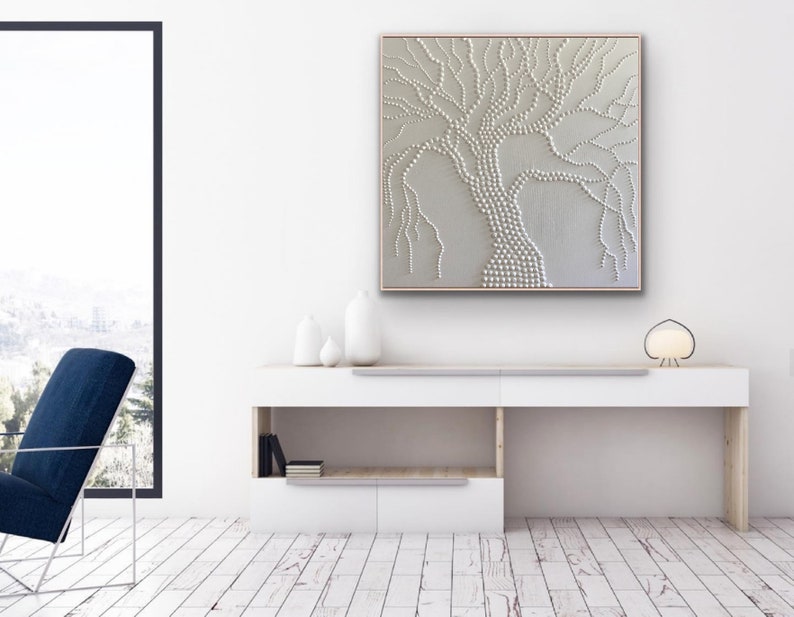 May include: A white textured canvas painting of a tree with a white background. The tree is made up of small white dots and lines.