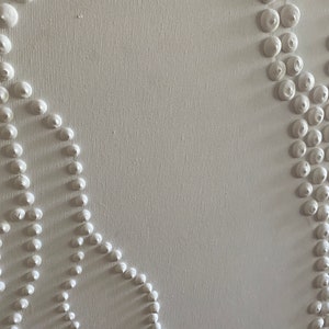 May include: White canvas with a textured surface. The canvas has a design of raised white circles in a pattern.