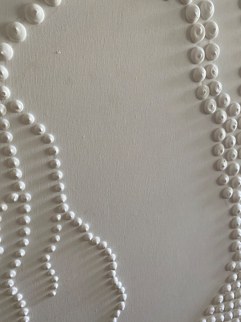 May include: White canvas with a textured surface. The canvas has a design of raised white circles in a pattern.