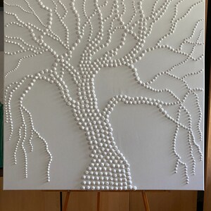 May include: White canvas painting of a tree with a thick trunk and branches made of small white circles.