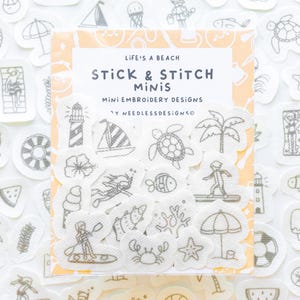 May include: A pack of "Stick & Stitch Minis" embroidery designs with a beach theme. The designs include a sailboat, lighthouse, palm tree, turtle, and other beach-related images. The package has the text "Life's a Beach".