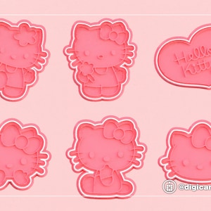 May include: Six pink plastic cookie cutters shaped like Hello Kitty. The cutters feature Hello Kitty in different poses, including holding a flower, sitting down, and with a heart-shaped bow. One cutter is shaped like a heart with the text "Hello Kitty" inside.
