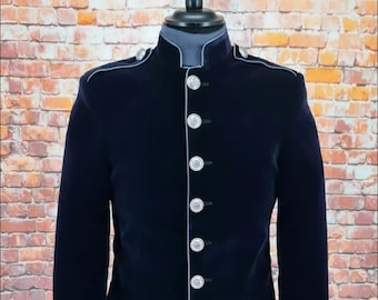 May include: A navy blue velvet blazer with a mandarin collar and silver buttons. The blazer has white piping around the edges and cuffs.