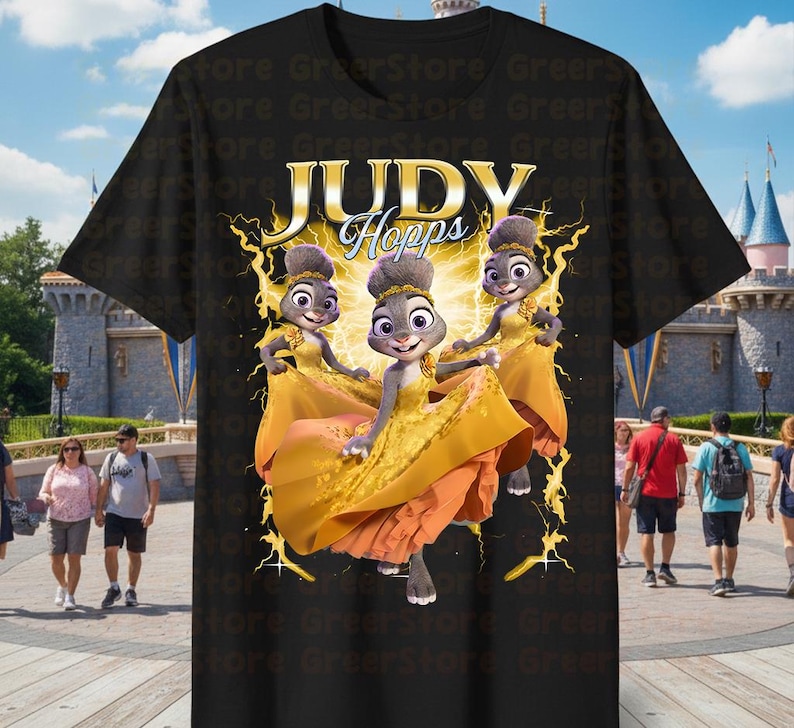 May include: Black t-shirt featuring a graphic of Judy Hopps from Zootopia in a yellow dress. The text "JUDY Hopps" is displayed above the character. The design includes a yellow lightning bolt effect.