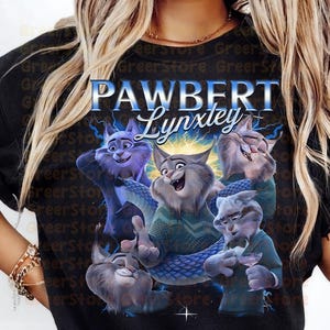 May include: Black t-shirt with a cartoon illustration of several cat characters, with the text "PAWBERT Lynxtey" in blue and white. The cats are depicted in different poses, with a blue and purple colour palette.