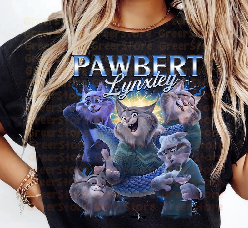May include: Black t-shirt with a cartoon illustration of several cat characters, with the text "PAWBERT Lynxtey" in blue and white. The cats are depicted in different poses, with a blue and purple colour palette.