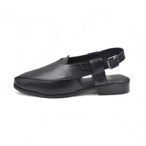 May include: Black leather slip-on sandals with a slingback strap and buckle closure.
