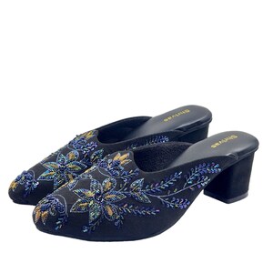 May include: A pair of black heeled mules with floral embroidery. The embroidery features iridescent blue and gold beads.