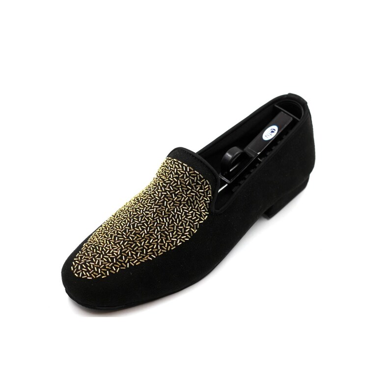 May include: Black suede loafers with gold embellishments. The loafers have a pointed toe and a low heel.
