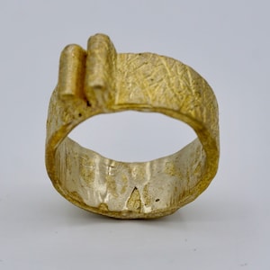 A brass ring with a unique texture and top