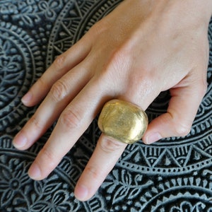 A huge brass ring, wraps around the finger