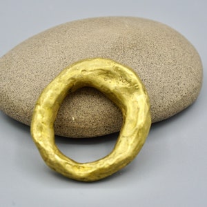 A thick  sculpted band ring with a material look, chunky ring with unique African design