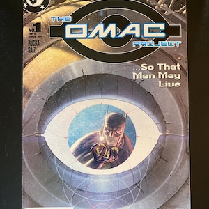 May include: The OMAC Project comic book, issue #1, featuring Batman. The cover has a futuristic design with the text "6 Months Until Infinite Crisis." The comic is from June 2005, with a barcode and price.