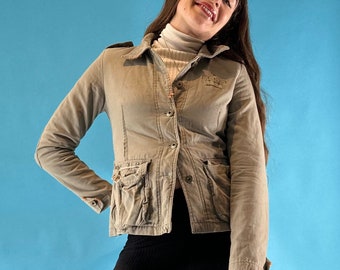 May include: A light brown utility jacket with a button closure and multiple pockets. The jacket has a crown logo on the chest.