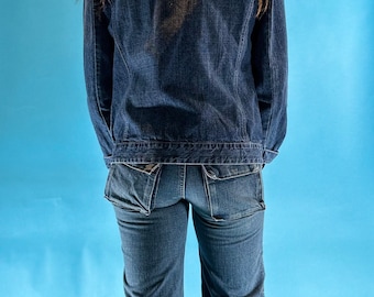 Vaqueros vintage Y2K de mezclilla lavada con corte de bota y tiro bajo con dobladillo sin rematar.