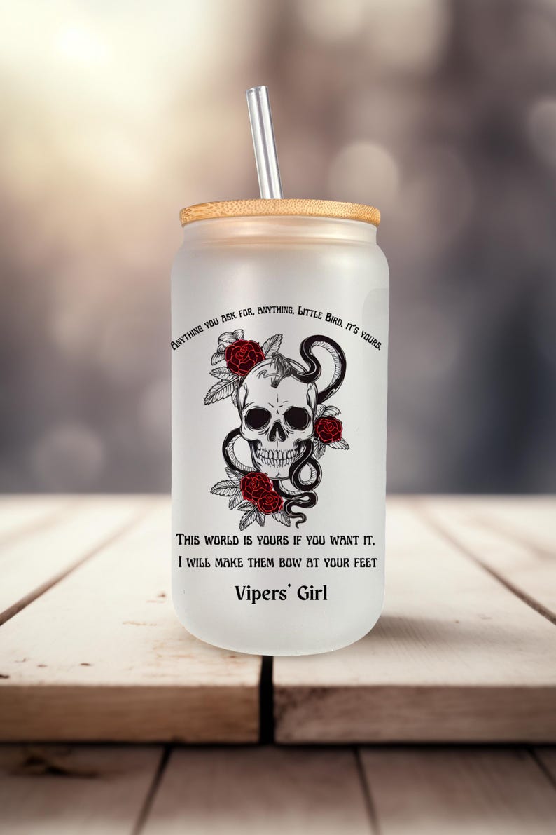May include: A white ceramic mug with a black handle and the text "But First, Coffee" in a bold, black font. The mug is set against a neutral background, highlighting its simple design.