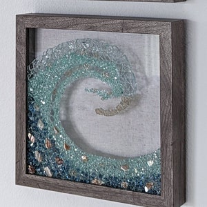 Gorgeous Ocean Wave Art in Seaglass colored, crushed glass. Frame color options with crushed sea shells and sleek clean front. Great gift!