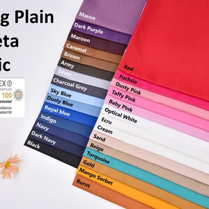 May include: A colour chart of 20 different fabric swatches, including mauve, dark purple, maroon, caramel, brown, army, silver, charcoal grey, sky blue, dusty blue, royal blue, indigo, navy, dark navy, black, red, fuchsia, dusty pink, taffy pink, baby pink, optical white, ecru, cream, sand, beige, turquoise, gold, mango sorbet, and burnt. The chart is labelled "Lining Plain Taffeta Fabric" and includes the Oeko-Tex Standard 100 certification logo.