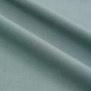 May include: A close-up of a smooth, light blue fabric with a subtle texture. The fabric is folded in a way that creates soft, flowing lines.