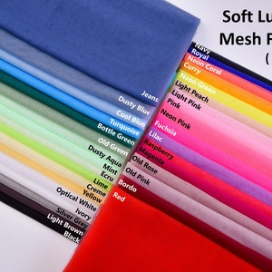 May include: A selection of 20 soft, sheer mesh fabric swatches in different colours, including navy, royal blue, neon coral, curry, neon green, light peach, light pink, pink, neon pink, fuchsia, lilac, raspberry, magenta, old rose, old pink, bordo, red, cream, yellow, optical white, ivory, silver grey, light brown, and black. The fabric is 10 metres long.