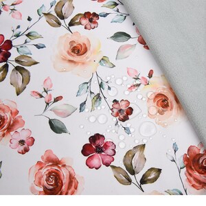 May include: Soft shell fabric with a floral print in shades of pink, red, and brown. The fabric is water repellent, breathable, and has a TPU layer bonded to it.  "Soft Shell Digital Print Fabric" is written at the top of the image.