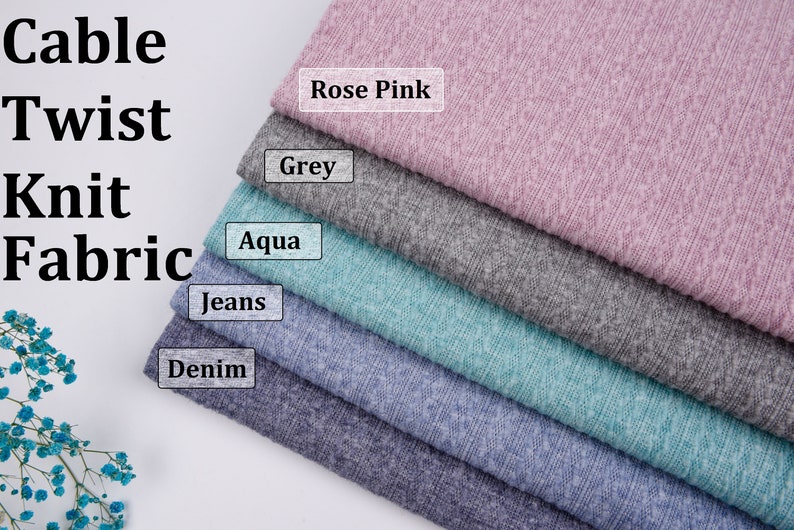 May include: A stack of five cable knit fabric swatches in different colors: rose pink, grey, aqua, jeans, and denim. The fabric has a textured, cable knit pattern.