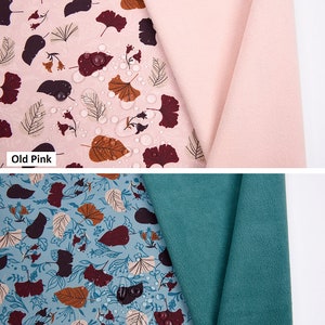May include: Two swatches of soft shell fabric with a floral print. The fabric is water repellent, breathable, and has a TPU layer bonded to it. The swatches are in the colors old pink and old green.