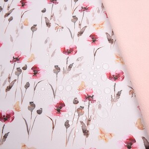 May include: Soft shell fabric with a floral print of pink poppies and butterflies on a white background. The fabric is water repellent, breathable, and has a TPU layer bonded to it.