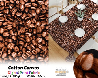May include: A brown cotton canvas tablecloth with a repeating pattern of coffee beans. The tablecloth is laid out on a wooden table with white plates and a potted plant. The text "Cotton Canvas Digital Print Fabric Weight: 390g/m Width: 150cm" is printed on the bottom of the image. The Oeko-Tex Standard 100 logo is also visible.