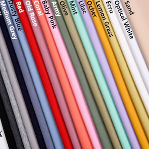 Puede incluir: Una variedad de muestras de tejido de punto de algodón y spandex en diferentes colores, incluyendo negro, melange oscuro, melange claro, gris plateado, azul marino, gris medio, azul polvoriento, rojo, rosa viejo, coral, rosa bebé, ejército, oliva, menta, lila, ocre, hierba limón, crudo, blanco óptico y arena.
