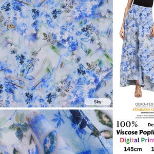 May include: Sky blue and white floral print fabric. The fabric features a watercolor-style design with leaves and flowers. The fabric is 145cm wide and weighs 155g/m. The fabric is made of 100% Viscose Poplin.