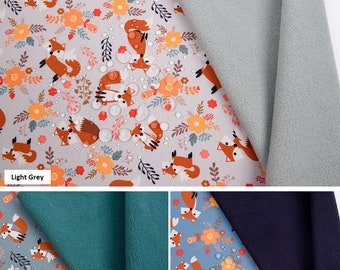 May include: Softshell digital print fabric featuring a repeating pattern of foxes, flowers, and water droplets. The fabric is light grey, water repellent, and breathable. Additional colors include dusty green and dusty blue.