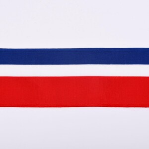 May include: A close-up shot of three horizontal ribbons in red, white, and blue. The top ribbon is a deep blue, the middle is white, and the bottom is a vibrant red. The ribbons are set against a plain white background.