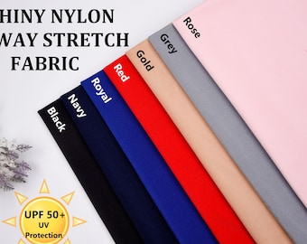 May include: Shiny nylon fabric in 8 colors: black, navy, royal blue, red, gold, grey, and rose. The fabric is 4-way stretch and has a UPF 50+ UV protection rating.
