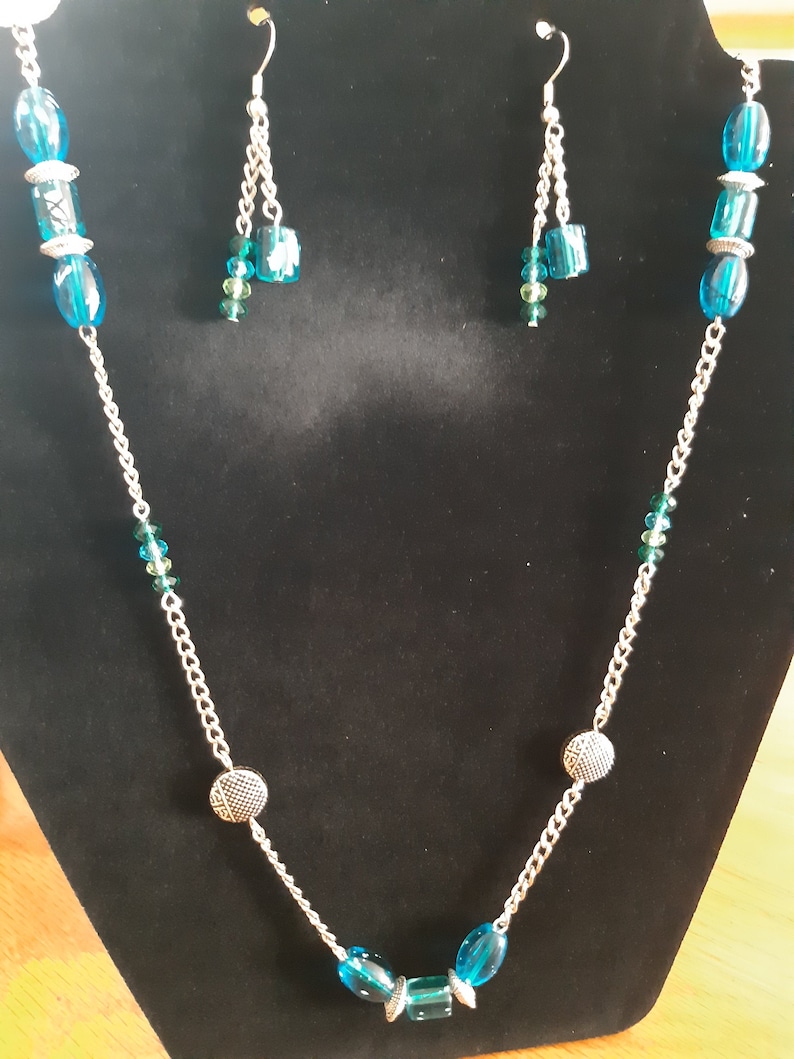 Turquoise and silver matinee necklace with matching earrings.