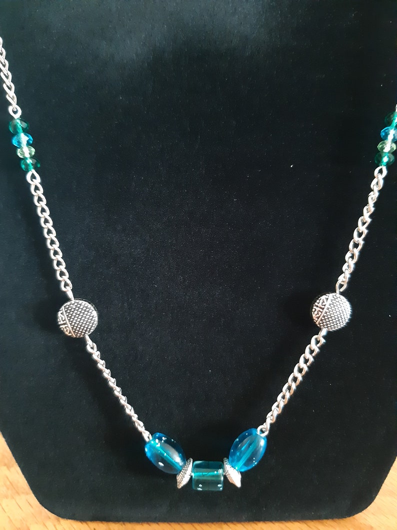 Turquoise and silver matinee necklace with matching earrings.