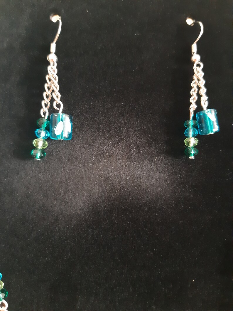 Turquoise and silver matinee necklace with matching earrings.