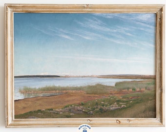 May include: A framed painting of a landscape with a body of water in the foreground and a distant city skyline in the background. The sky is blue with white clouds. The painting is in a light wood frame.